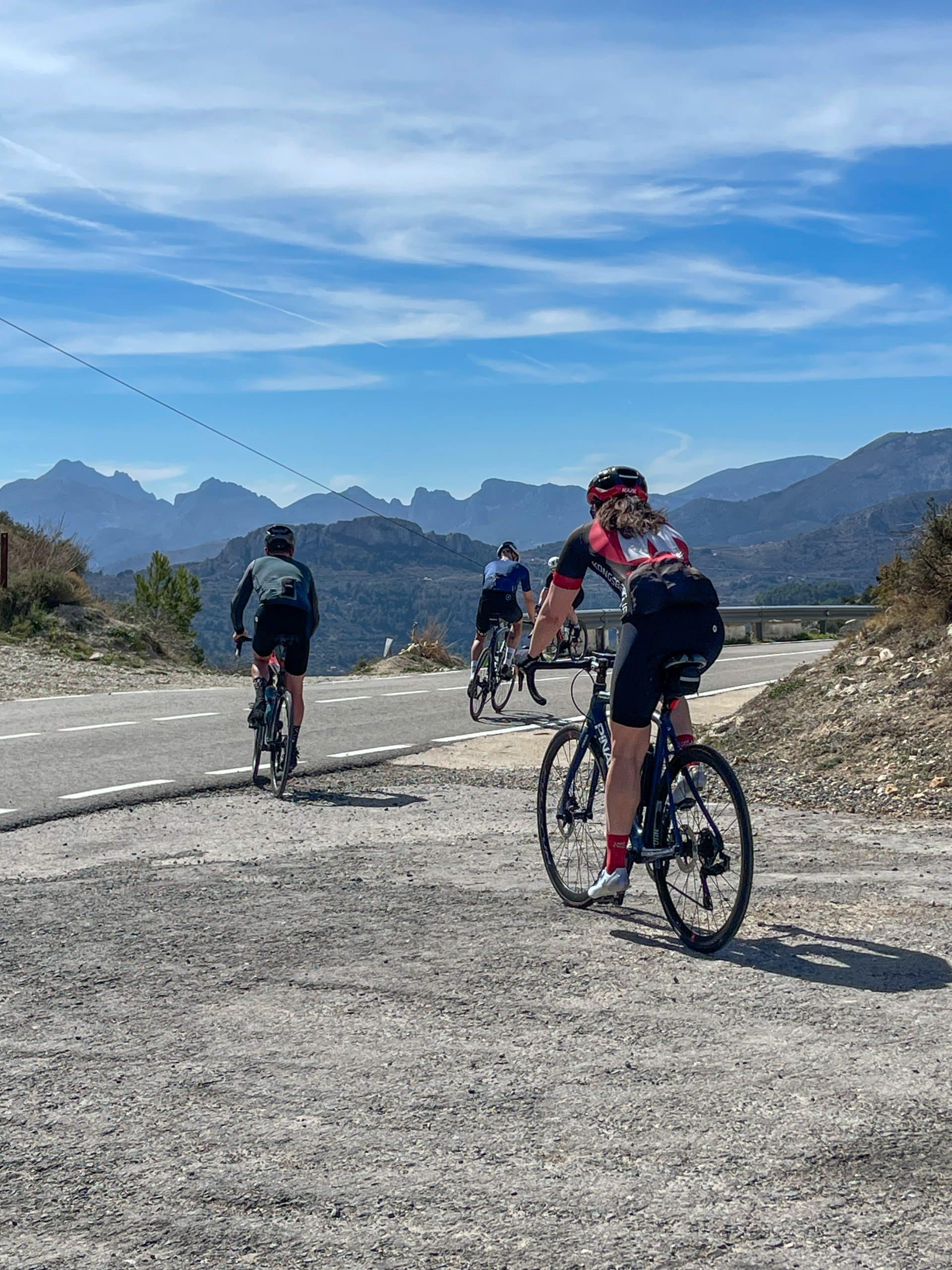 Syklister på en fjellvei under blå himmel i innlandet bak Costa Blanca
